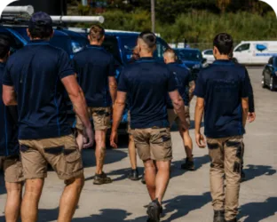 Plumbers walking to their service vans on a Bronte job
